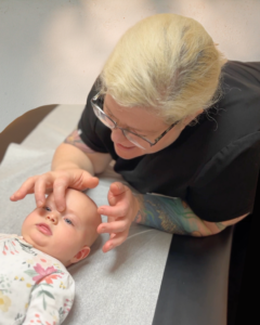 Baby receiving gentle head touch